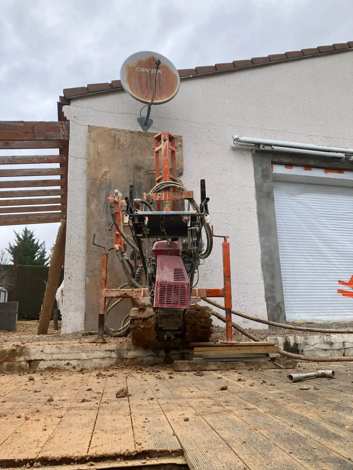 Foreuse de micropieux en action contre la façade à Vichel